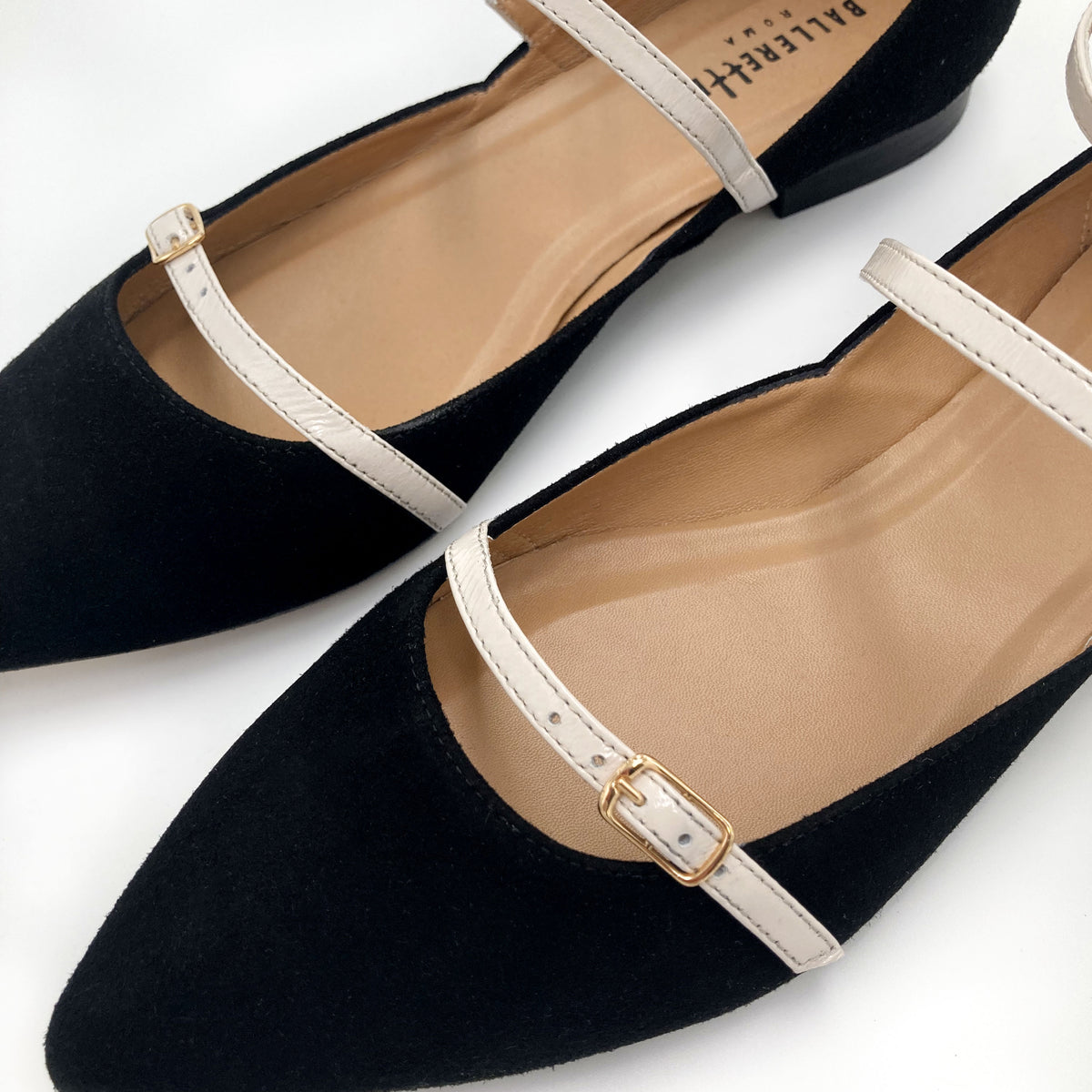 Black suede ballet flats with cream straps