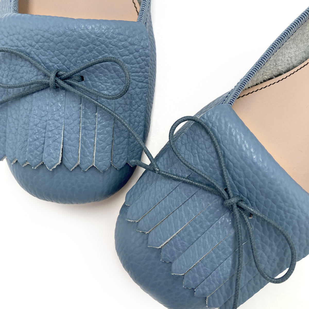 Denim-blue leather moccasins with fringes